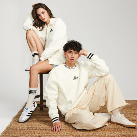 Model in the FW'23 stripe crewneck and zip jacket in cream