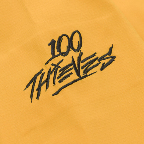 100 Thieves logo on Foundations SS'24 3L Shell Jacket - Gold