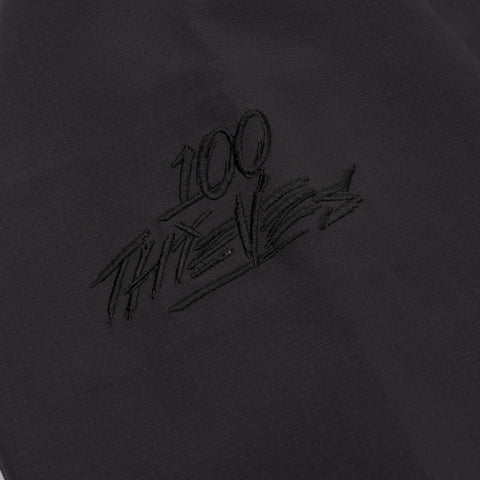 100 thieves logo on Foundations SS'24 3L Shell Jacket - Graphite