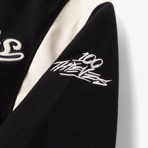100 thieves logo on sleeve of Senior Varsity Jacket - Black