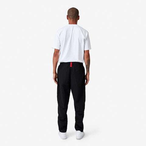 back of 100 Thieves Foundation nylon pants with elastic waistband and 100 Thieves metal aglet tipped drawstrings in the color black