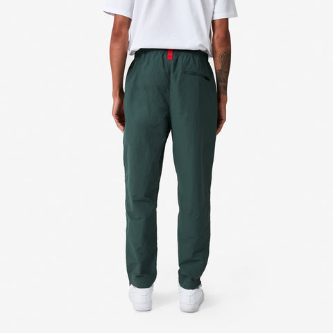 back of 100 Thieves Foundation nylon pants with elastic waistband and 100 Thieves metal aglet tipped drawstrings in the color alpine