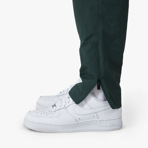 zip on tapered bottom of 100 Thieves Foundation nylon pants in the color alpine
