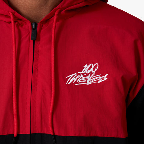 100 Thieves logo embroidered on left side of 100 Thieves Foundation two-tone windbreaker jacket with full zip in black