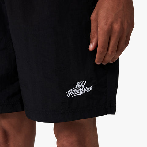 100 Thieves logo embroidered on left side of 100 Thieves Foundations nylon short with extra wide elastic waistband and 100 Thieves metal aglet tipped drawstrings in color black.