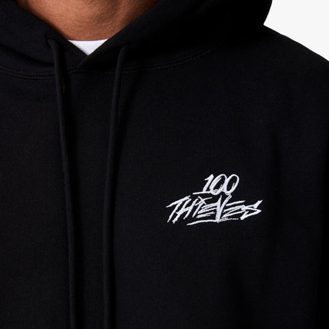 100 Thieves logo embroidered on left side of 100 Thieves Foundation heavyweight black fleece hoodie