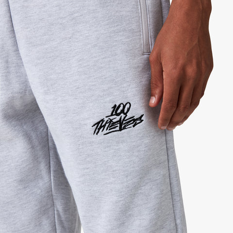 100 Thieves Logo embroidered on left side of 100 Thieves Foundation slim fit sweatpant in grey