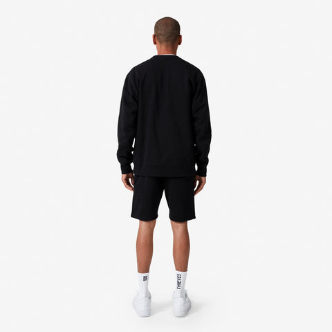 Back of 100 Thieves Foundations heavy-weighted crewneck in black - on 6'1 model